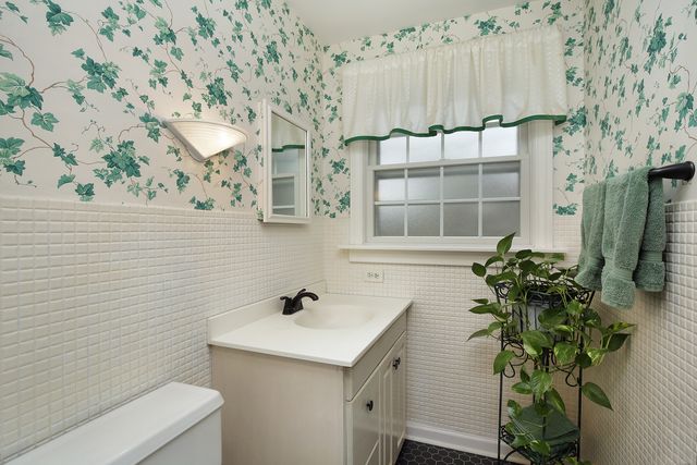 a bathroom with a sink and mirror with shower