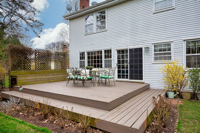 a view of a house with backyard and sitting area