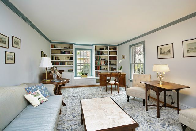 a living room with furniture and a book shelf