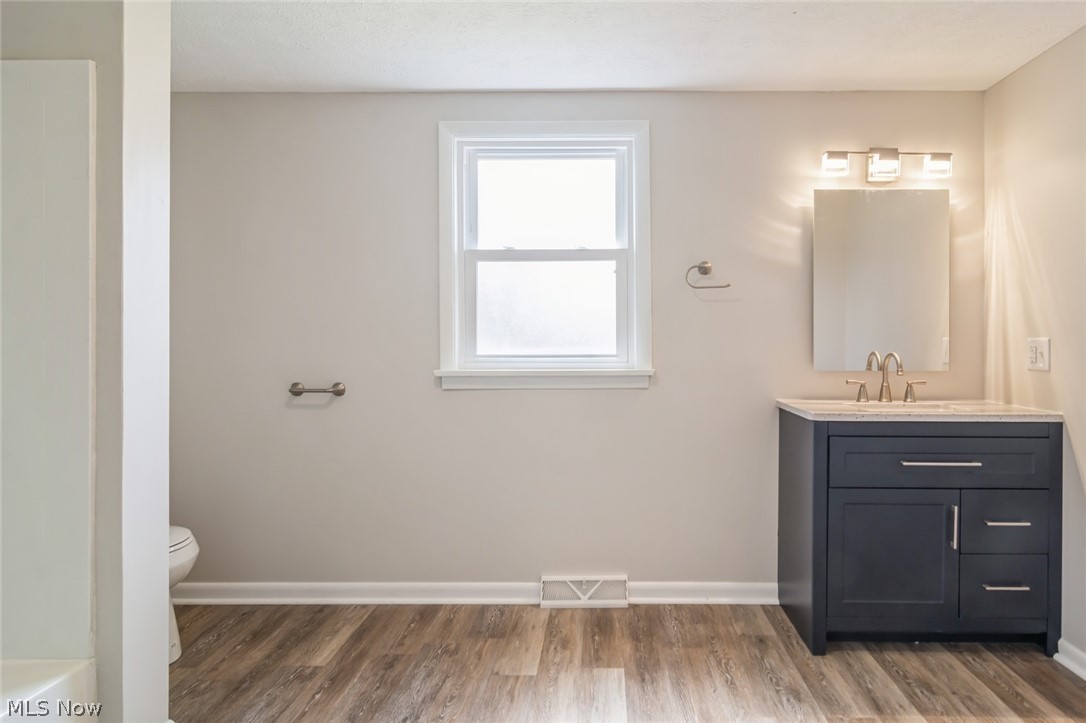 37012 Sugar Ridge Road North Ridgeville, OH 44039 - Photo 12 of 26 Bathroom featuring vanity, hardwood / wood-style flooring, and toilet
