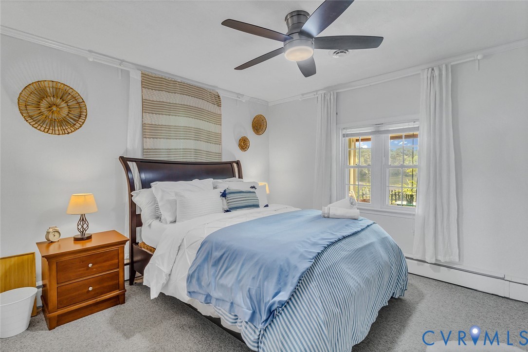437 Plainview Road Kinsale, VA 22488 - Photo 22 of 50 a bedroom with a bed and a chandelier