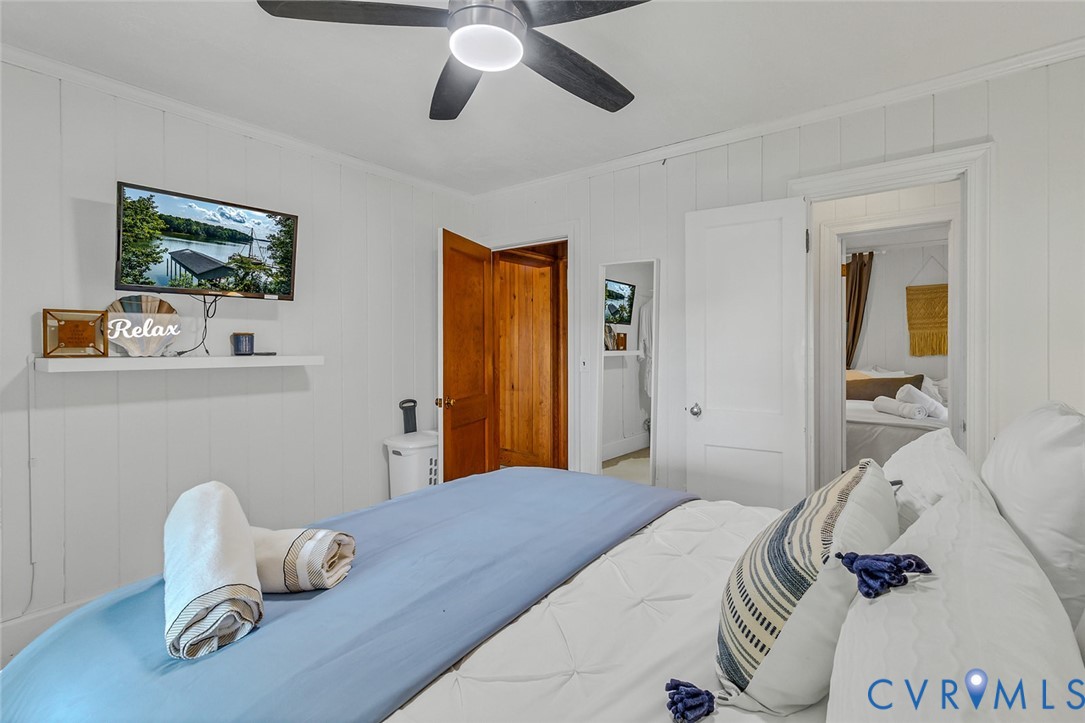 437 Plainview Road Kinsale, VA 22488 - Photo 23 of 50 a bedroom with a bed and a chandelier