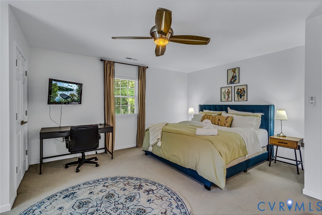 437 Plainview Road Kinsale, VA 22488 - Photo 30 of 50 a bedroom with a bed a couch and a window