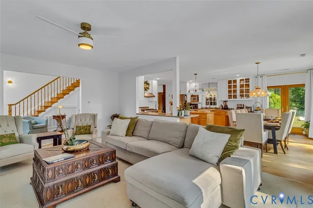 a dining room with furniture large windows and wooden floor