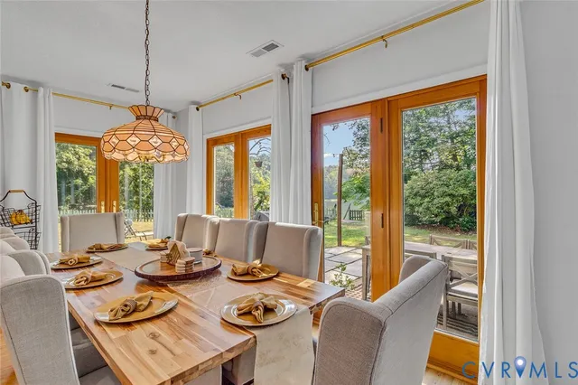 a dining room with furniture and a floor to ceiling window