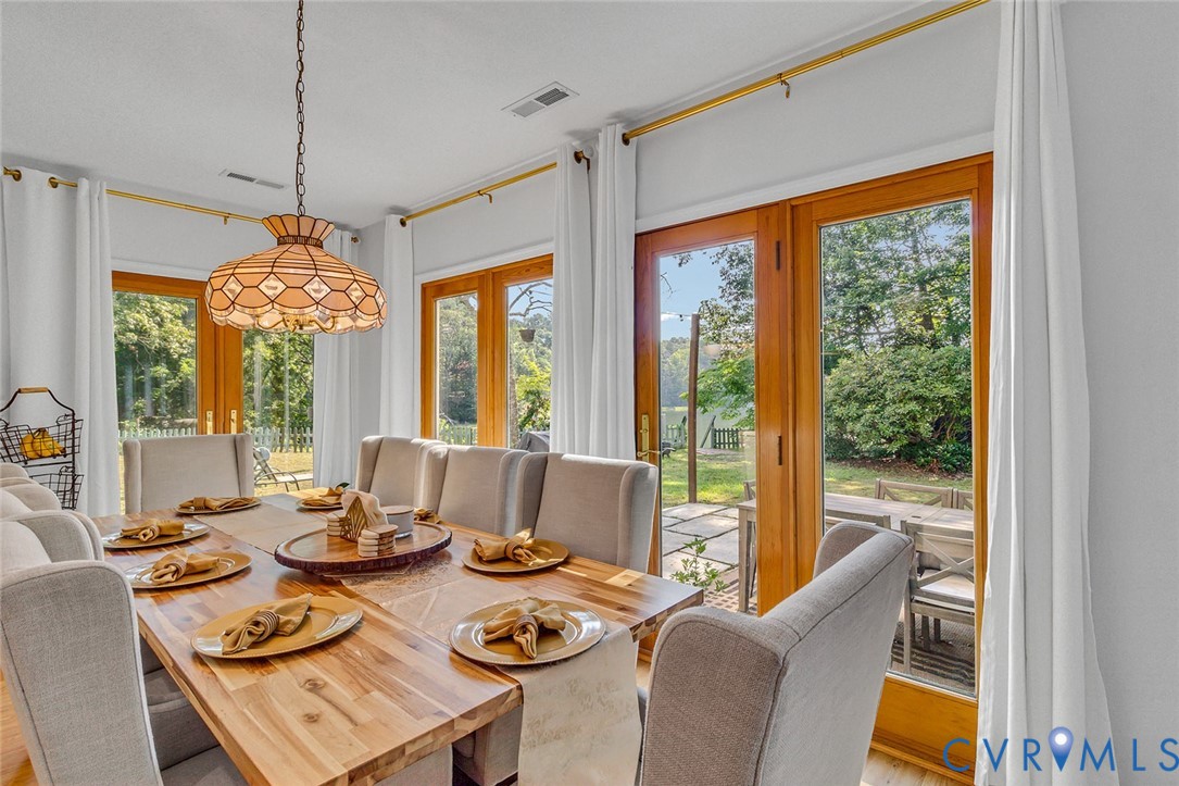 437 Plainview Road Kinsale, VA 22488 - Photo 9 of 50 a dining room with furniture large windows and wooden floor