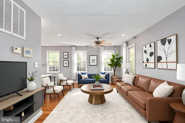 a living room with furniture and a potted plant