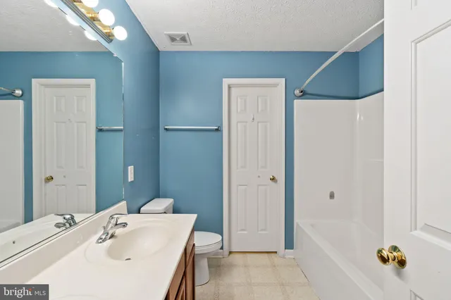 a bathroom with a tub shower and a sink
