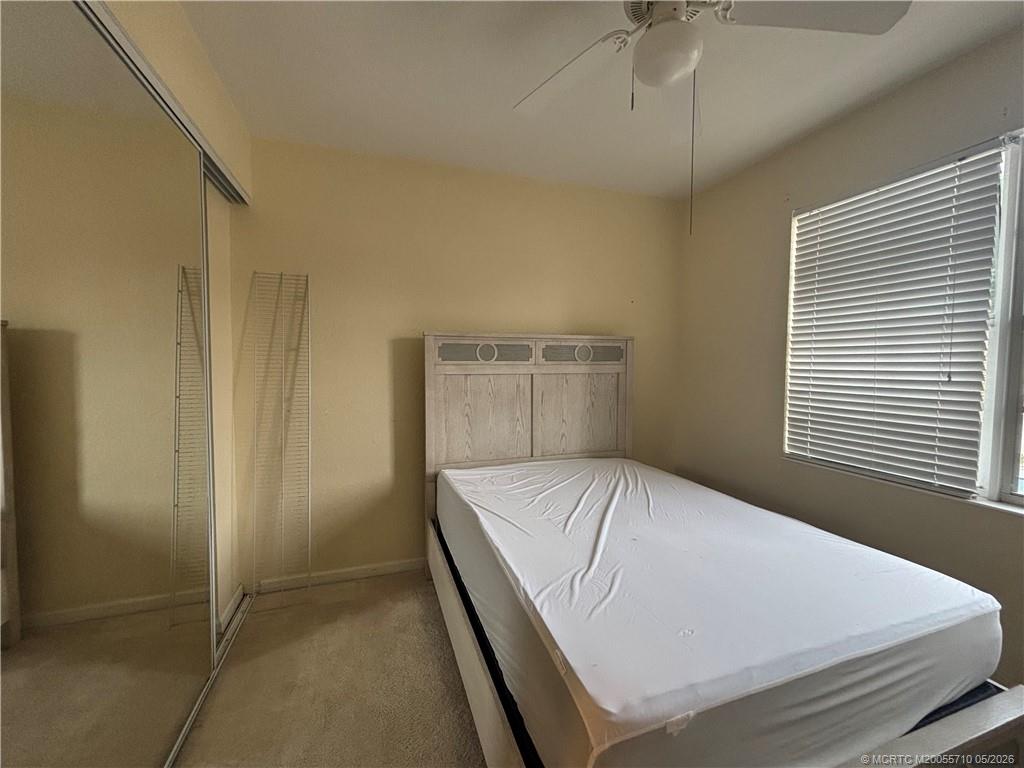 262 Southwest Walking Path, Unit 262 Stuart, FL 34997 - Photo 33 of 39 a bedroom with a bed and a window