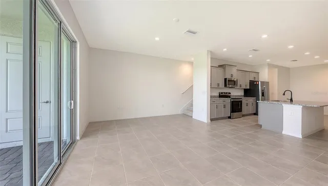 a view of kitchen with refrigerator and microwave