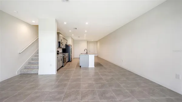 a view of a hallway with a kitchen