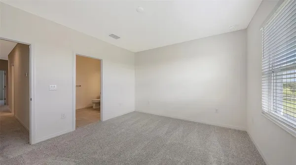 an empty room with windows and closet