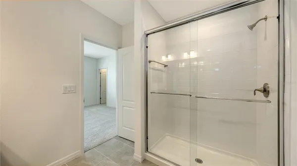 a bathroom with a glass shower door