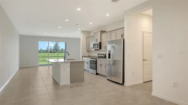 a kitchen with stainless steel appliances a refrigerator and a stove top oven