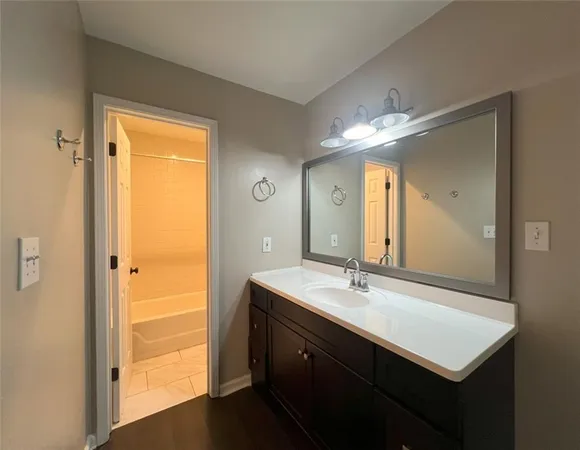 a bathroom with a sink a mirror and a shower
