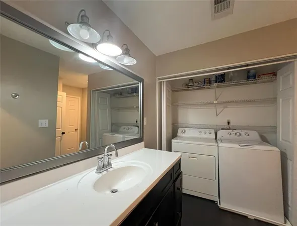 a bathroom with a sink a toilet and a mirror