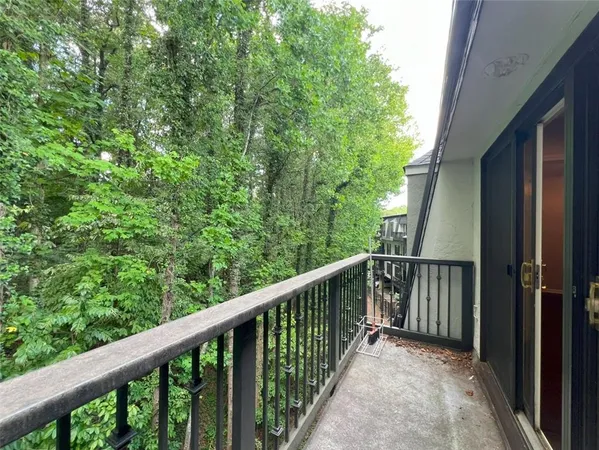 a view of a balcony with wooden floor and fence