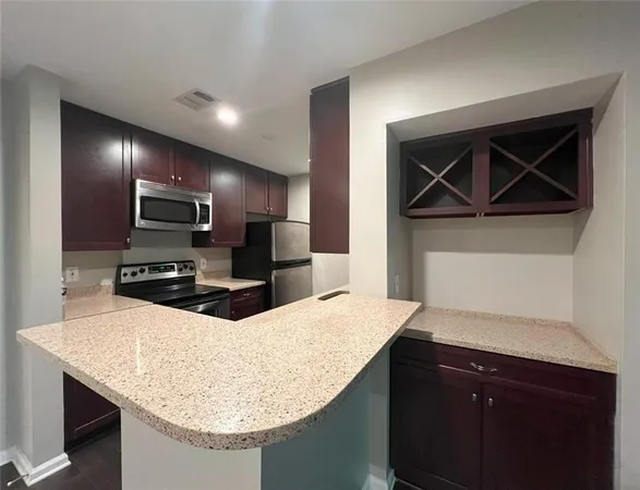 a kitchen with a sink a microwave and refrigerator