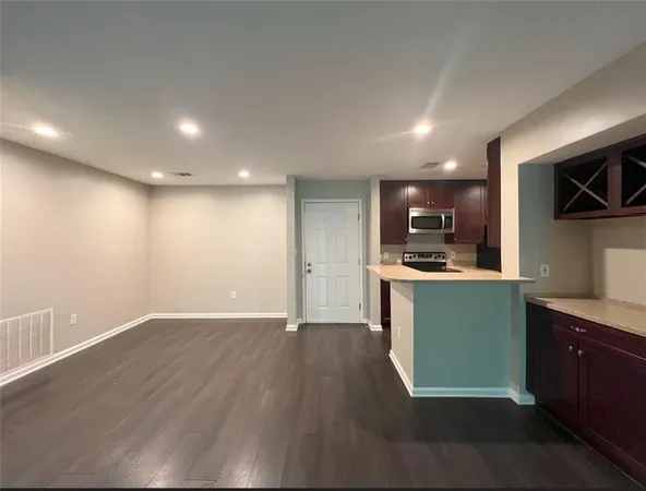 a kitchen with a refrigerator and a microwave