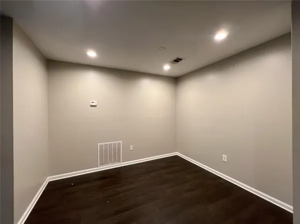 a view of a room with wooden floor