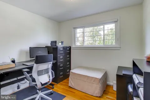 a livingroom with workspace and a window