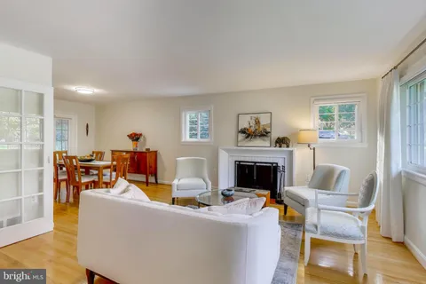 a living room with furniture a fireplace and a window