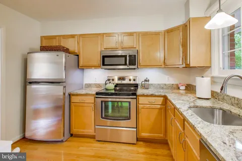 a kitchen with a sink stove and refrigerator