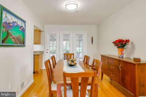 a dining room with furniture and wooden floor
