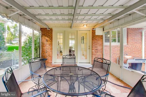 a dining room with furniture a chandelier and wooden floor