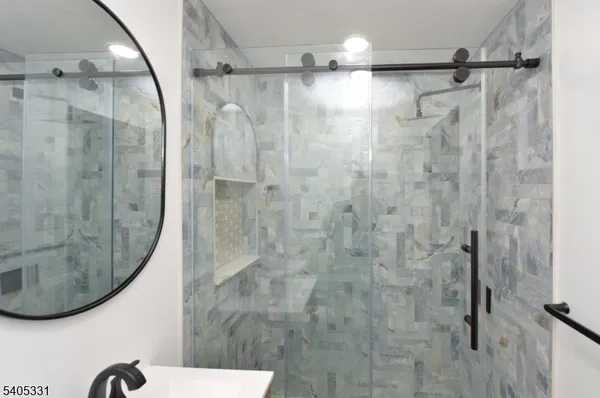 a bathroom with a shower and a mirror