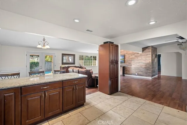 a large kitchen with kitchen island a sink stainless steel appliances and cabinets