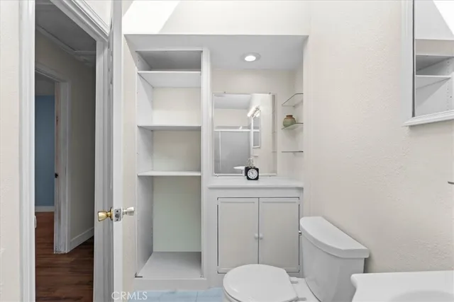 a bathroom with a toilet a sink and mirror