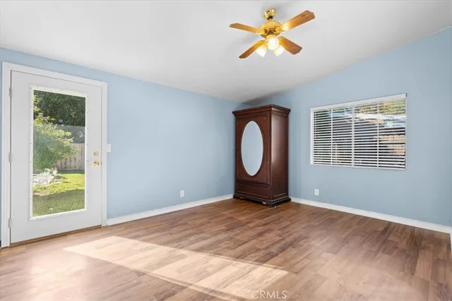 a view of a room that has a window and wooden floor