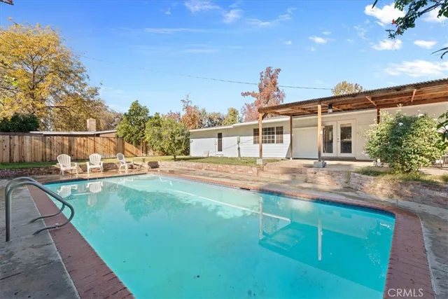 a view of a house with backyard and sitting area