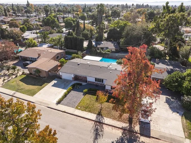 an aerial view of a house with a yard