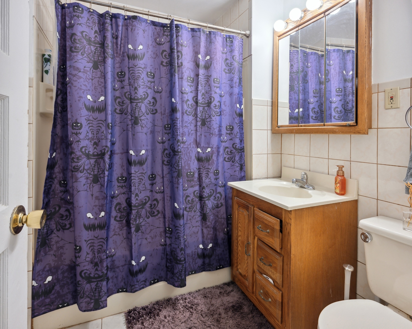 3837 North Lakewood Avenue Chicago, IL 60613 - Photo 15 of 19 a bathroom with a granite countertop sink and a toilet