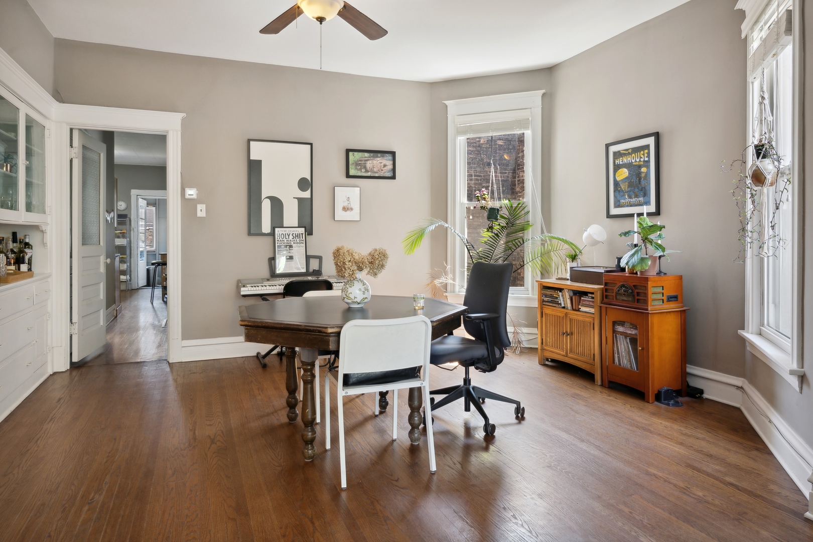 3837 North Lakewood Avenue Chicago, IL 60613 - Photo 4 of 19 a dining room with wooden floor a chandelier a glass table and chairs