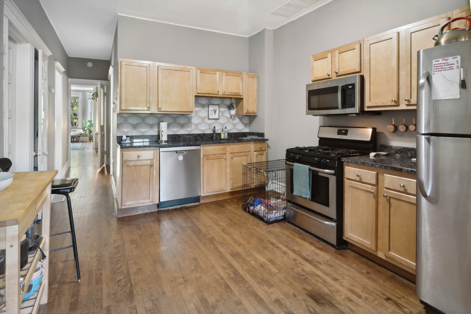 3837 North Lakewood Avenue Chicago, IL 60613 - Photo 5 of 19 a kitchen with granite countertop a stove top oven microwave and cabinets