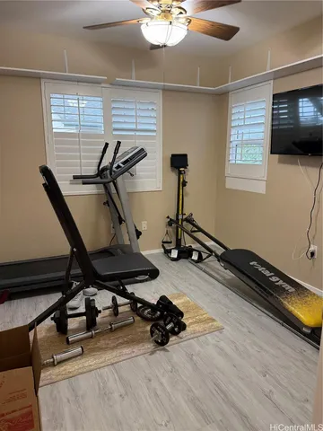 a room with gym equipment and windows