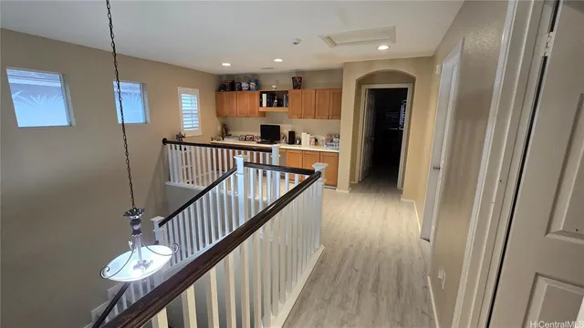 a view of entryway and hall with wooden floor