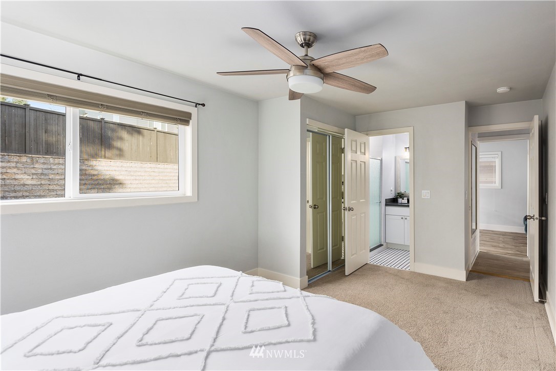 33 243rd Place Southeast Bothell, WA 98021 - Photo 13 of 28 a bedroom with a large bed and a chandelier