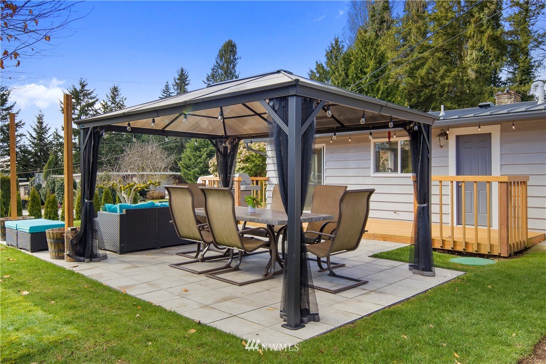 33 243rd Place Southeast Bothell, WA 98021 - Photo 21 of 28 a view of a patio with table and chairs near a yard
