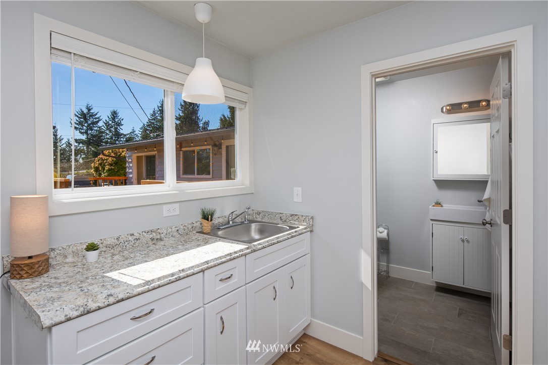 33 243rd Place Southeast Bothell, WA 98021 - Photo 24 of 28 a bathroom with a granite countertop sink and a mirror