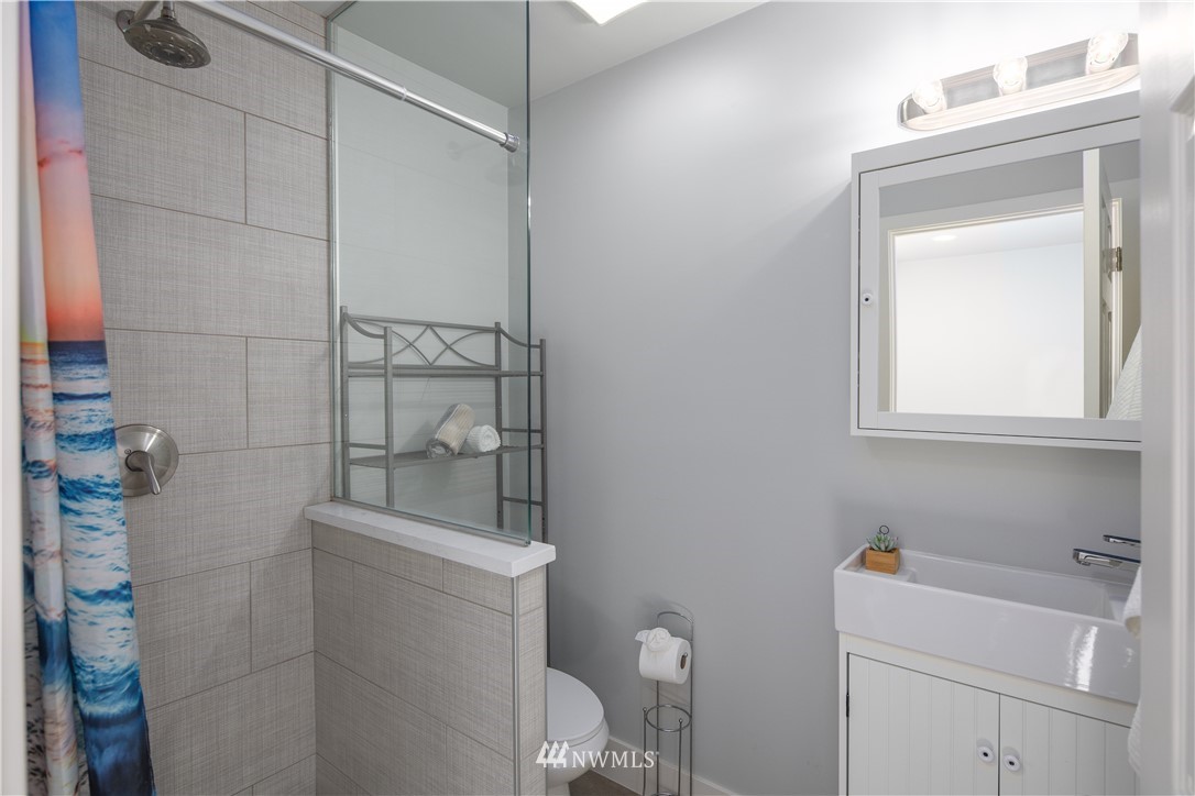 33 243rd Place Southeast Bothell, WA 98021 - Photo 25 of 28 a bathroom with a shower toilet and sink