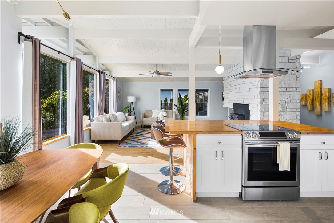 33 243rd Place Southeast Bothell, WA 98021 - Photo 6 of 28 a living room with furniture a fireplace and a chandelier