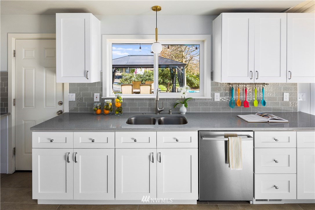 33 243rd Place Southeast Bothell, WA 98021 - Photo 9 of 28 a kitchen with white cabinets and window