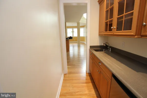 a kitchen with kitchen island granite countertop a sink cabinets and appliances
