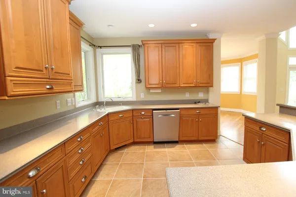a kitchen with stainless steel appliances a refrigerator and cabinets