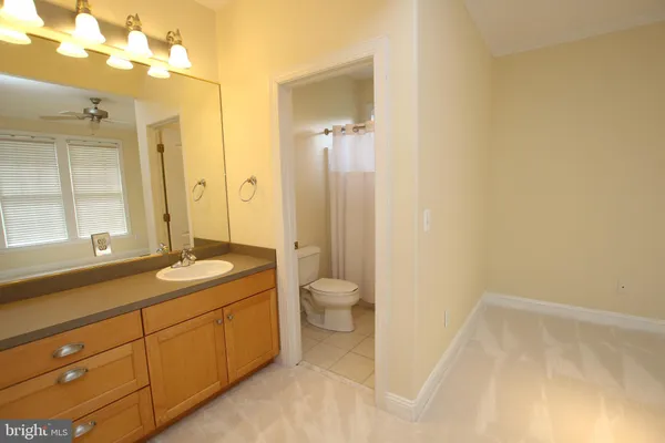 a white toilet sitting next to a white sink