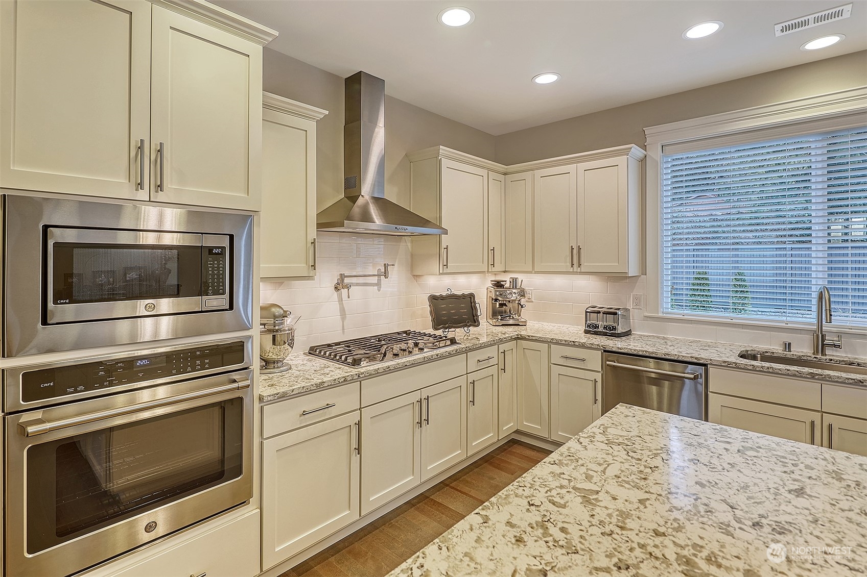 43 242nd Street Southeast Bothell, WA 98021 - Photo 8 of 40 a kitchen with cabinets stainless steel appliances and wooden floor
